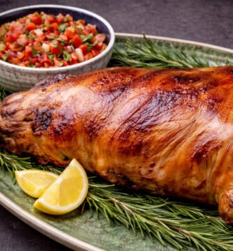 Lechón a las brasas en kamado con piel crujiente y salsa criolla de rocoto